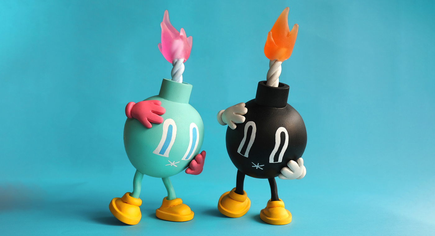 Image of two Panic Bomb art toys: a turquoise one and a black one.